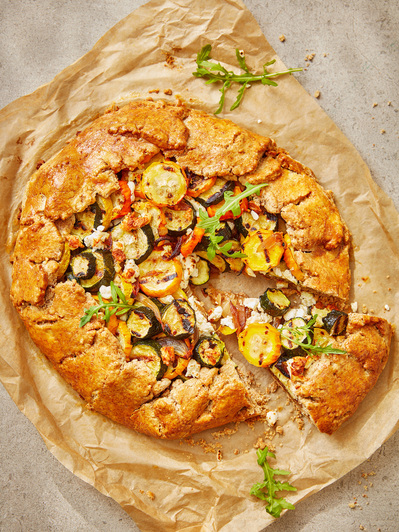 A courgette tart with dappled sunlight, perfect for editorial, advertising and restaurant food photography, shot by food photographer, Sid Ali