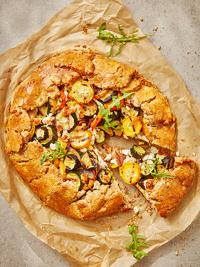 A courgette tart with dappled sunlight, perfect for editorial, advertising and restaurant food photography, shot by food photographer, Sid Ali