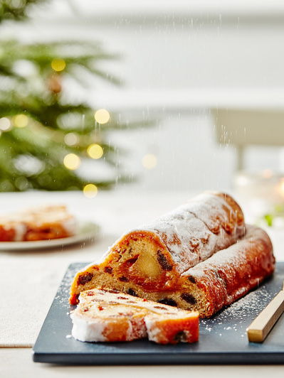 A christmas cake on chopping board with christmas tree in background shot for asda, perfect for editorial and restaurant food photography, shot by food photographer, Sid Ali