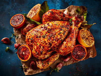 Roasted citrus chicken on blue background, perfect for editorial, advertising and restaurant food photography, shot by food photographer, Sid Ali