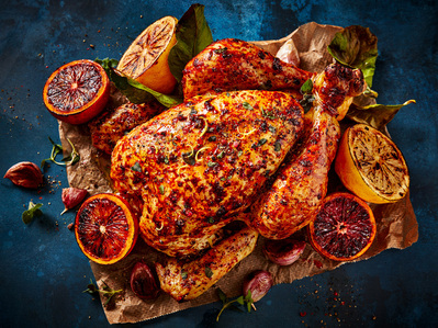 Roasted citrus chicken on blue background, perfect for editorial, advertising and restaurant food photography, shot by food photographer, Sid Ali