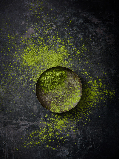 A scattering of matcha powder on dark background, perfect for editorial and restaurant food photography, shot by food photographer, Sid Ali