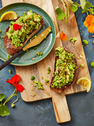 broadbeans on toast shot in a editorial style with nasturtium flowers, perfect for editorial and restaurant food photography, shot by food photographer, Sid Ali