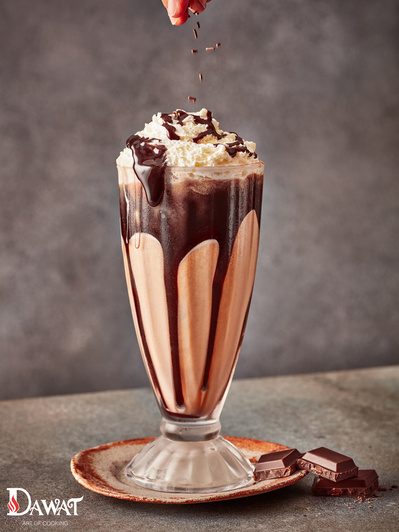 A chocolate milkshake with falling sprinkles, perfect for editorial, advertising and restaurant food photography, shot by food photographer, Sid Ali