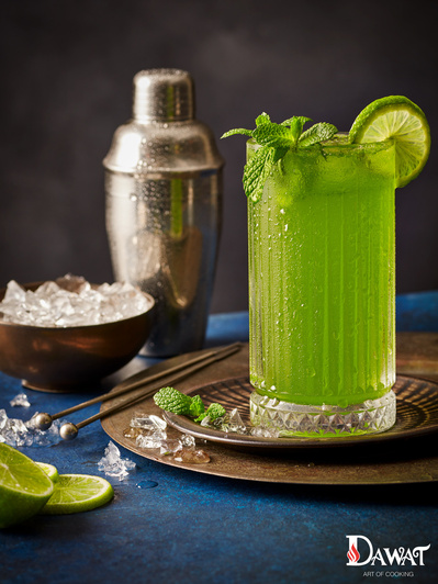 a beautiful green cocktail shot in a editorial style on dark background, with ice scattering,  perfect for editorial and restaurant food photography, shot by food photographer, Sid Ali