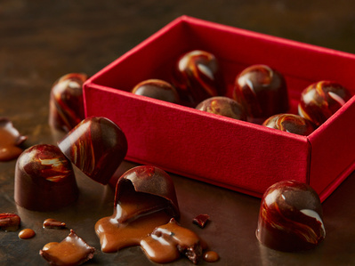 AA cklose up of KFC gravy chocolates with sime broken revealing the gravy, perfect for editorial, advertising and restaurant food photography, shot by food photographer, Sid Ali