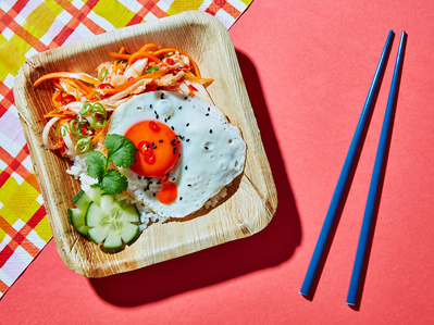 A korean fried egg and kimchi breakfast on a bright pink background , perfect for editorial, advertising and restaurant food photography, shot by food photographer, Sid Ali
