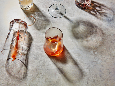 A mix of summer cocktails on a stone background with long hard shadows, perfect for editorial and restaurant food photography, shot by food photographer, Sid Ali