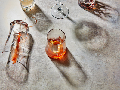 A mix of summer cocktails on a stone background with long hard shadows, perfect for editorial and restaurant food photography, shot by food photographer, Sid Ali