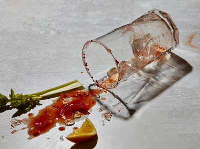 A spilt bloody mary cocktail on a stone surface, perfect for editorial, advertising and restaurant food photography, shot by food photographer, Sid Ali