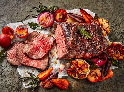 A spring roast lamb with plums, onions and carrots, perfect for editorial, advertising and restaurant food photography, shot by food photographer, Sid Ali