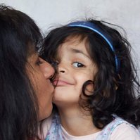 family photograph of mother kissing toddler