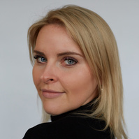 Professional photography studio portrait of a blonde woman against grey backdrop  