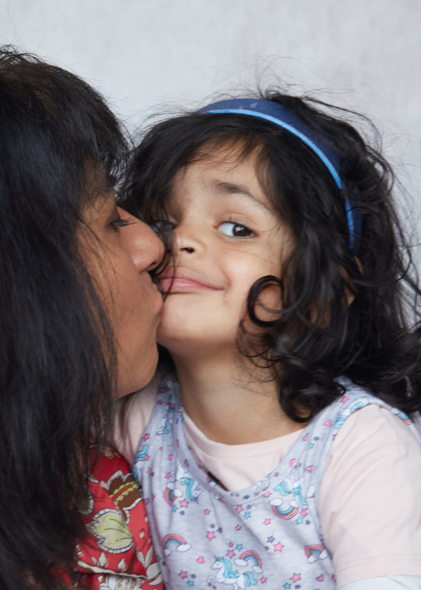 family photograph of mother kissing toddler