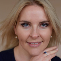 close-up studio portrait of a blonde woman against neutral backdrop  