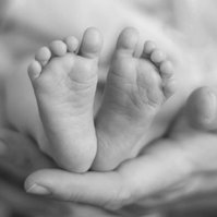 newborn feet held in parents hands 