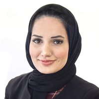 Professional Headshot of a woman wearing a black hijab against a white background
