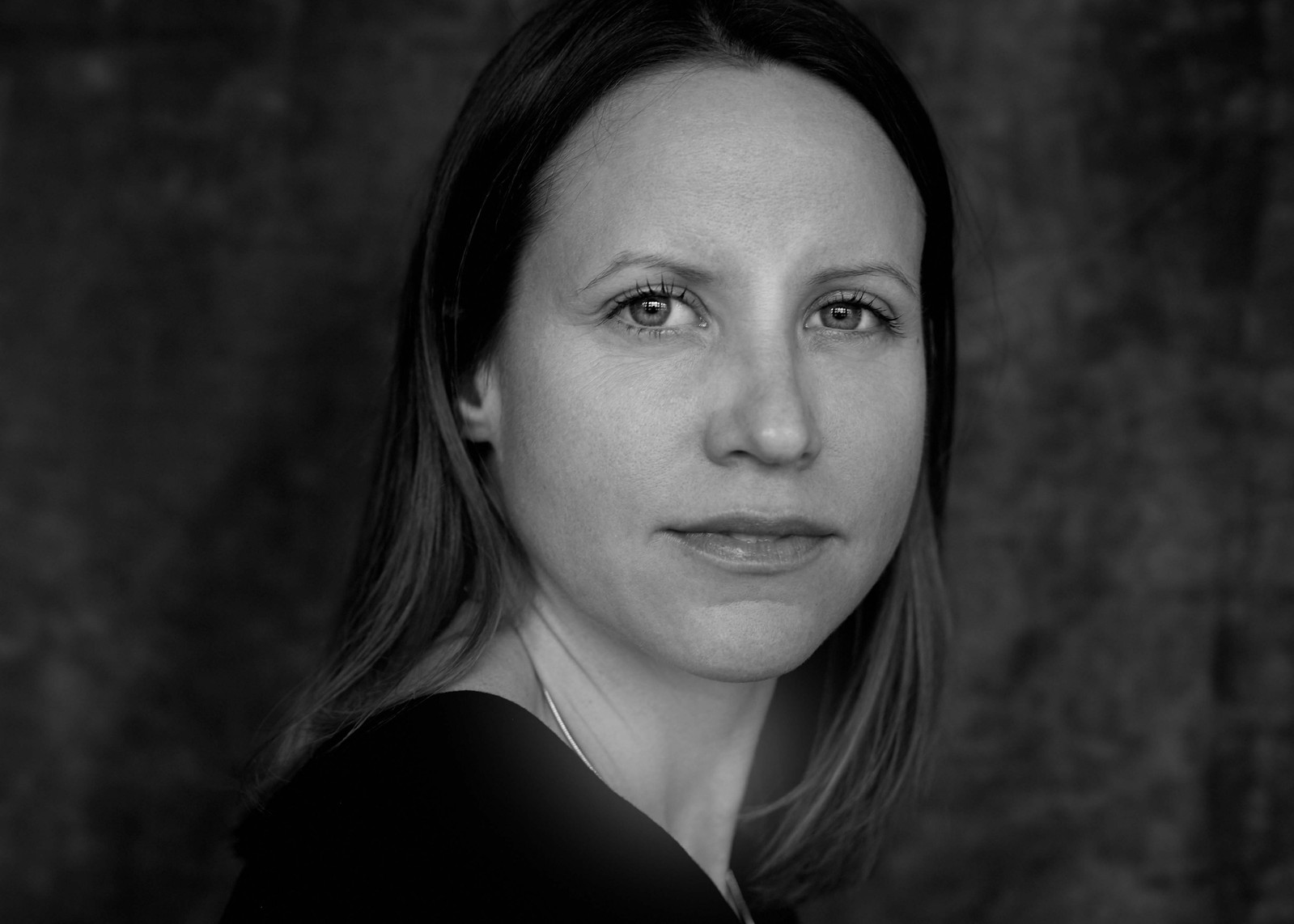 Award winning Professional black and white portrait of a women against a grey backdrop in a photography studio