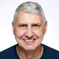Professional Headshot of a man wearing a black top against a white background
