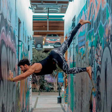 yoga vinyasa ashtanga balancing between 2 walls 