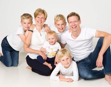 Family portrait of young relaxed family taken in the studio by Sandry Studio - professional photographers. Relaxed and informal.