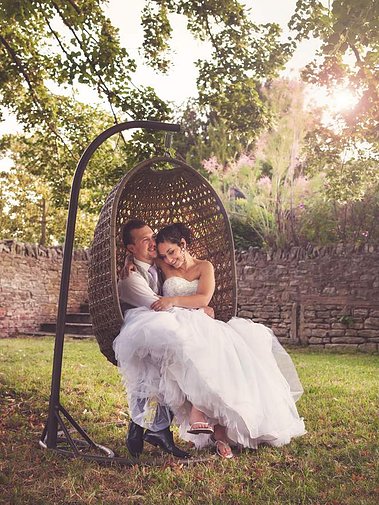 Wedding Photograph oWedding photo at Birtsmorton Court near Worcester in the background by Robin Sandry of Sandry Studio Worcester UK professional photographer tree swing evening light informal relaxed cool