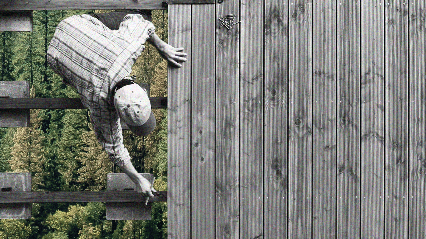 Photo illustration of construction worker working on wood paneling, in black and white and from above, with green-toned profile view of forest trees underneath spacing in the paneling. 