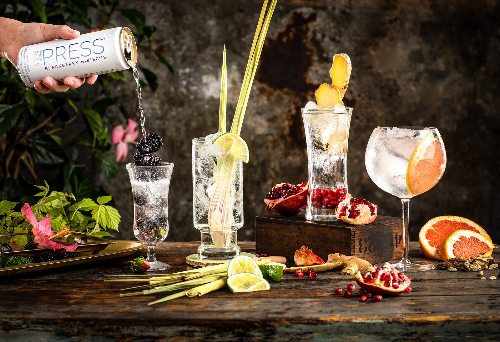 A series of vibrant and enticing cocktail photographs featuring Press Seltzer and fresh fruity garnishes. Taken by a skilled drink photographer, the images showcase a variety of colorful and refreshing seltzer drinks in tall glasses with a pour