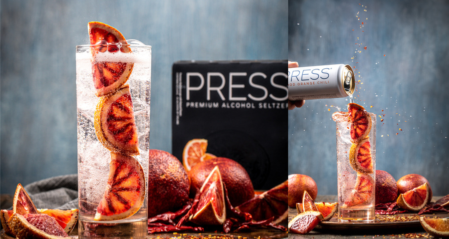 Diptych of blood orange press seltzer in a glass with three blood orange wedges in front of the press seltzer packaging. Second image can of press seltzer pouring into same glass with whole and sliced blood oranges. 