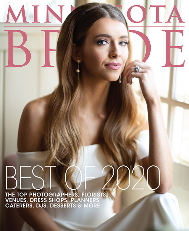 Minnesota bride cover image with bride in simple white dress near window  with long brown hair. 