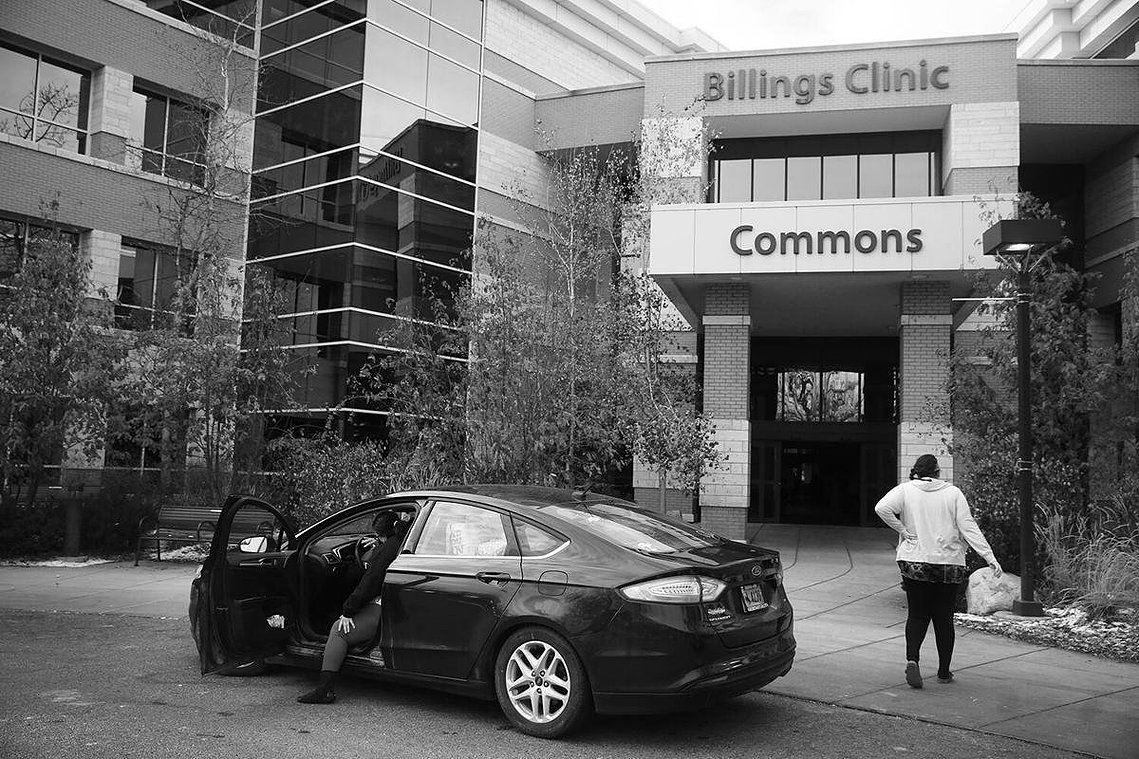 Rubbing her back as she leaves the car and enters the clinic, Jalissa tried to stretch a bit before heading into the clinic for an appointment on moving day. This was the second trip to the doctor in less than a week.