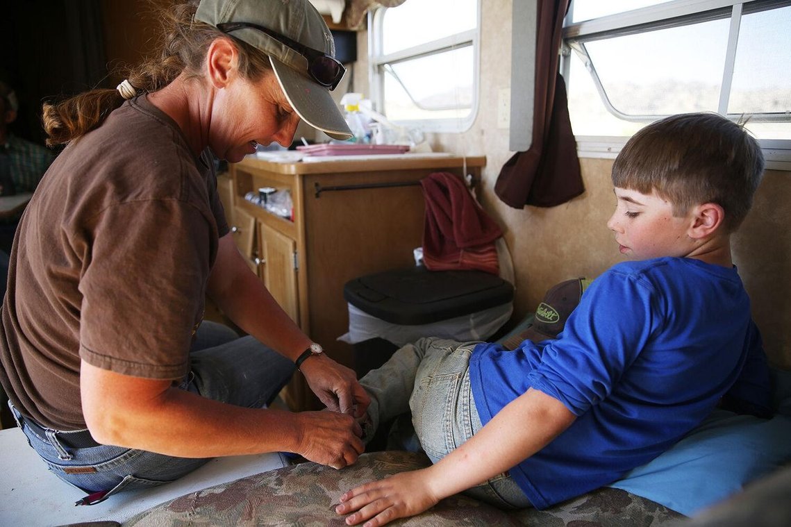 Chris Curuchet places a bandaid on Ben’s heal that had rubbed sore again after the morning’s work. Joe and Jamie watered the horses and got all the animals put away before returning the trailer to get out of the sun and relax for a while.