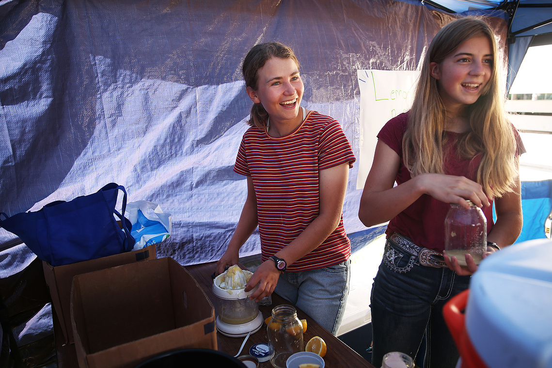 Elsa laughs and Elizabeth Farris laugh with the new Buffalo High School FFA advisor Taylor Rieniets, not pictured, during the beef show on July 30. The homemade lemonade stand is run by Buffalo’s FFA members and was open throughout the week.