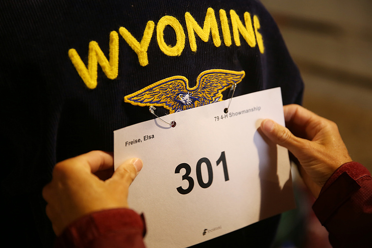 Elsa’s mom Michelle Freise checks the position of Elsa’s competitor number after pinning it onto her FFA jacket before pig showmanship on July 29, 2020. Freise showed one pig in both 4-H and FFA showmanship and again in the afternoon for market classes.