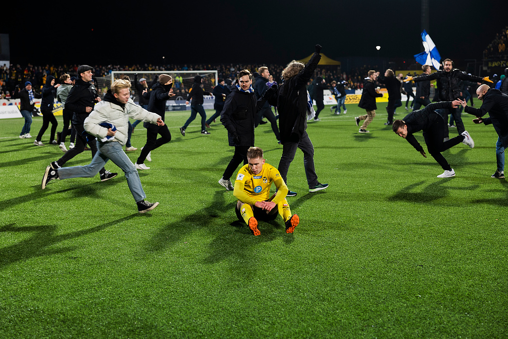 KuPS-HJK Väre Areenalla. HJK voitti tasapelillä mestaruuden. HJK:n kannattajat riensivät kentälle ottelun loputtua. Keskellä KuPSin Taneli Hämäläinen.