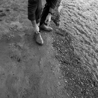 Black-and-white walking detail photographed with the Sony a7III showing documentary movement and autofocus performance for a real-world review.
