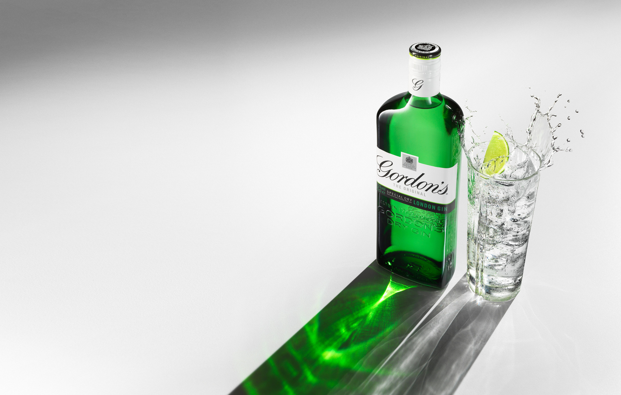 Gordon's gin bottle and splash photography. Beverages and alcohol product & advertising photography by Timothy Hogan Studio in Los Angeles