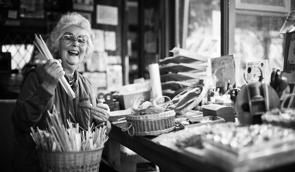 Meet the team portrait of an old lady holding knitting needles in her haberdashery shop in Norfolk. Shot by Norwich commercial, freelance portrait photographer Matt Keal.