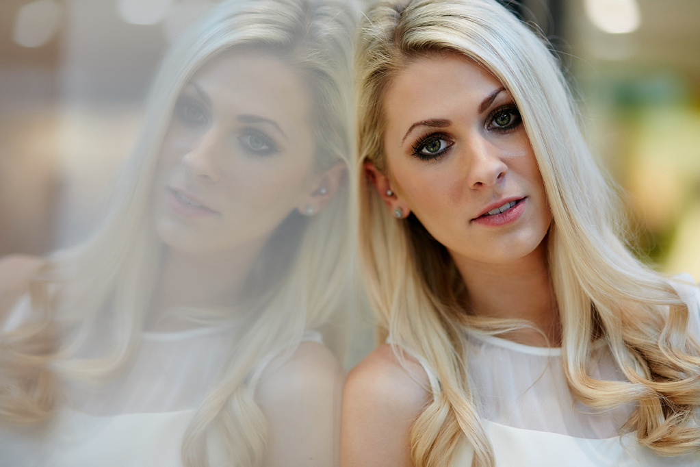 Headshot of a blonde, female London model leaning against a reflective surface looking directly into the camera. Shot by Norwich commercial, freelance portrait photographer Matt Keal.
