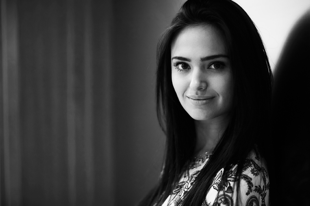 Black and white, side-profile portrait of a young actress looking into the camera at a photography studio. Shot by Norwich commercial, freelance portrait photographer Matt Keal.