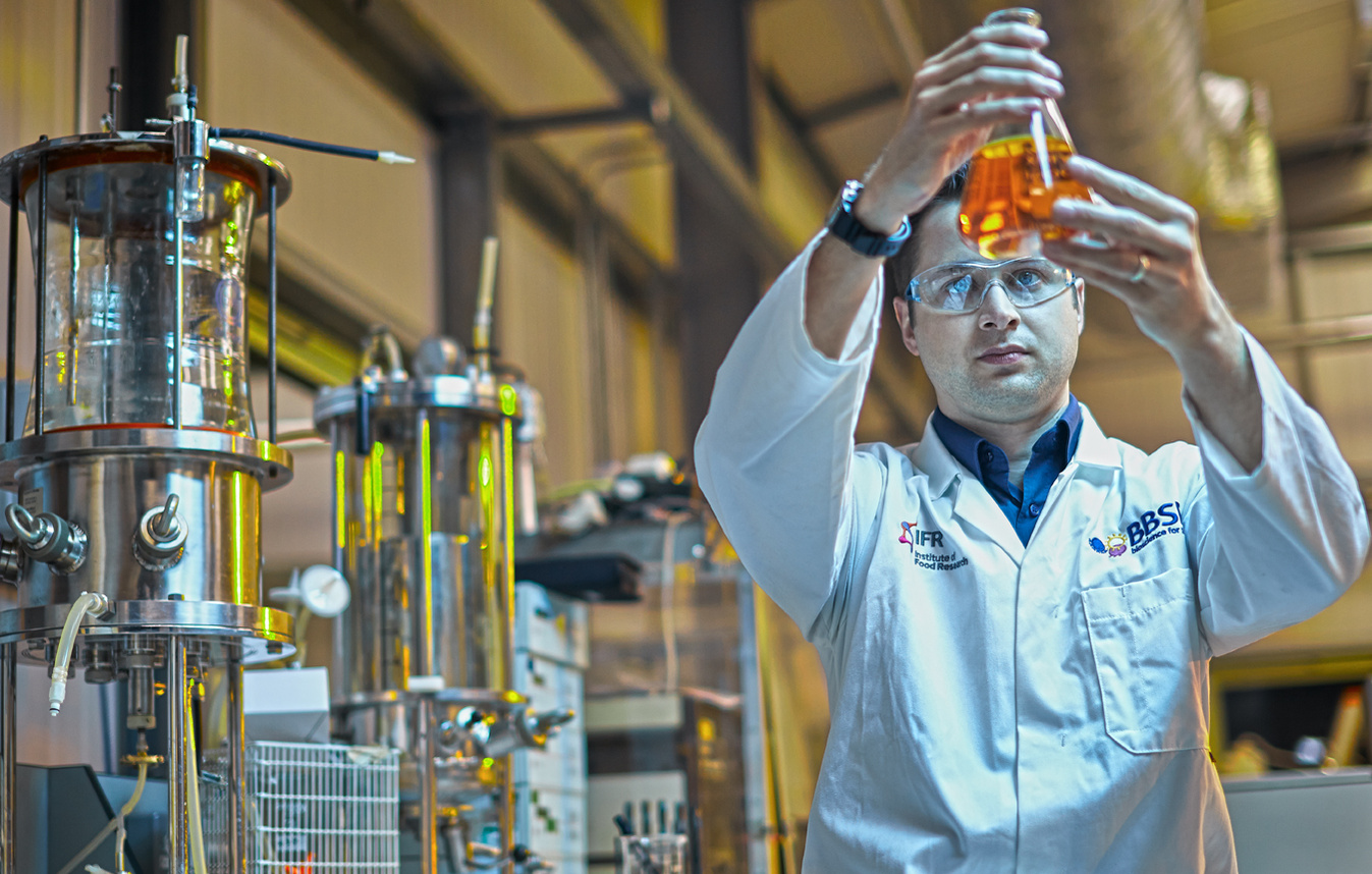 Portrait of a scientist experimenting with chemicals in a laboratory. Shot by Norwich commercial, freelance portrait photographer Matt Keal.