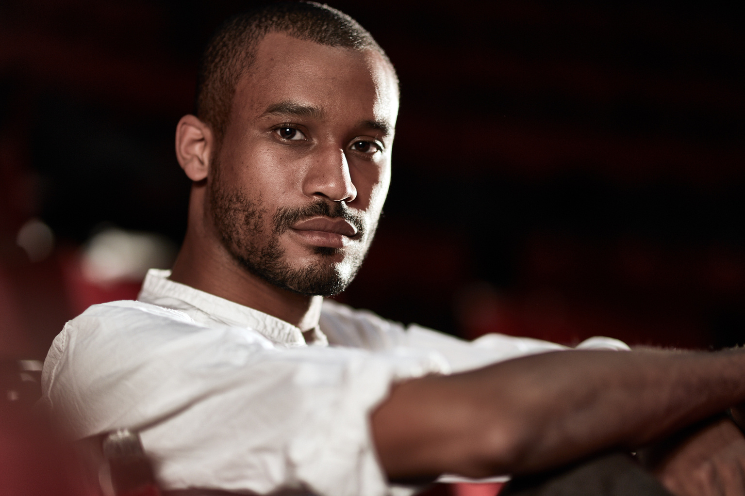 Headshot of a black male model from London wearing a white shirt with the sleeves rolled up. Shot by Norwich commercial, freelance portrait photographer Matt Keal.