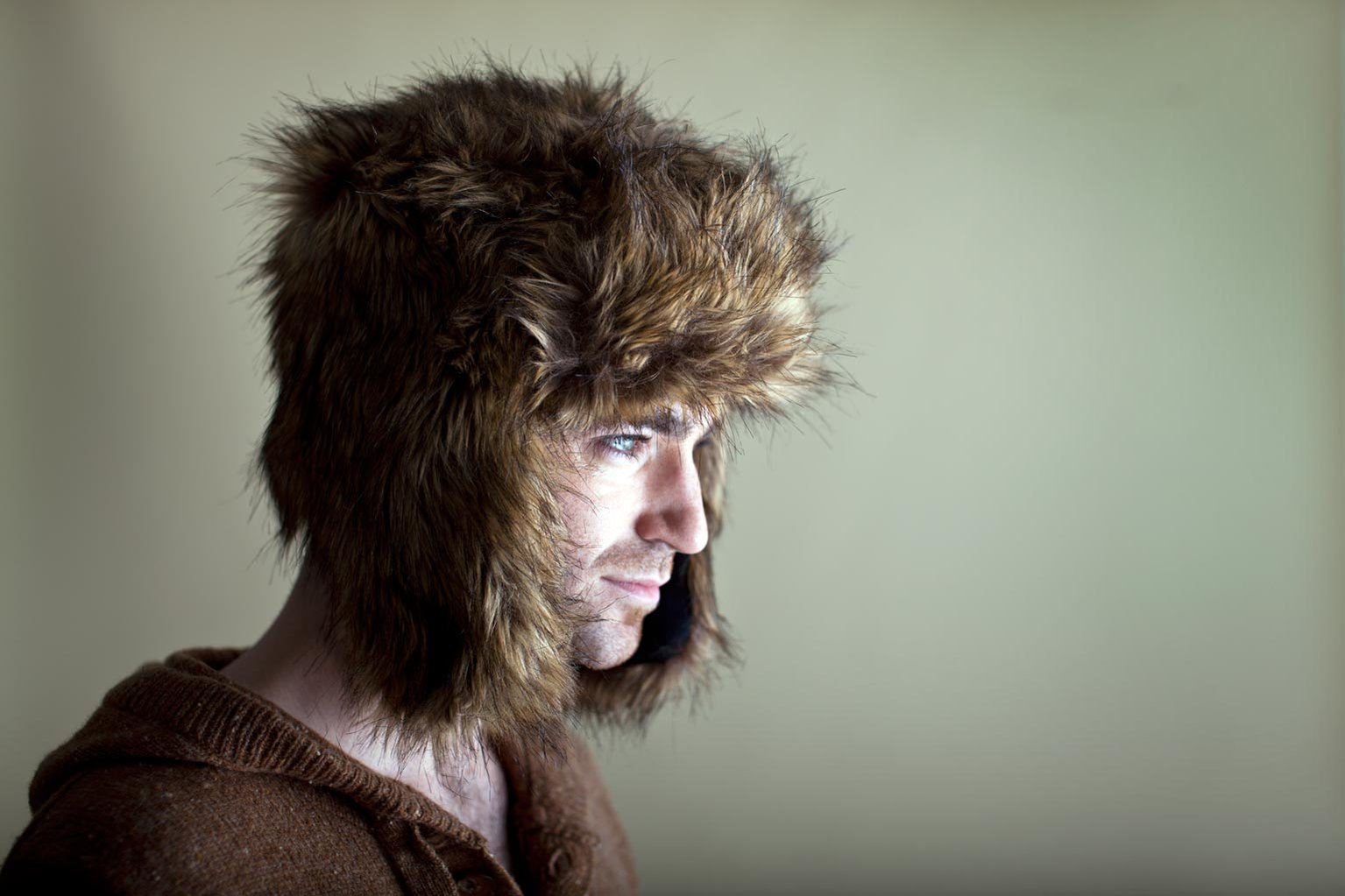 Head and shoulders, side-profile portrait of a male model wearing a Russian hat. Shot by Norwich commercial, freelance portrait photographer Matt Keal.