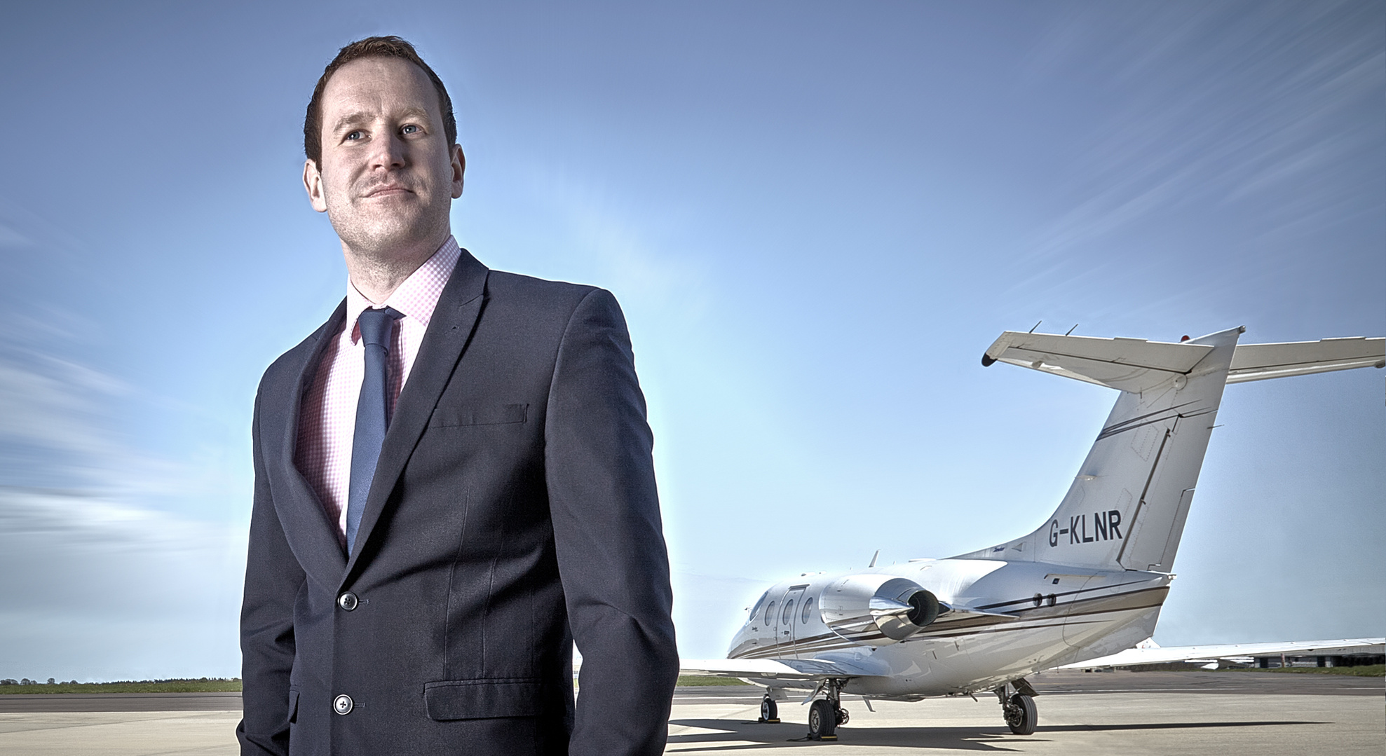 Corporate portrait of a businessman in front of his private jet before it takes off. Shot by Norwich commercial, freelance portrait photographer Matt Keal.