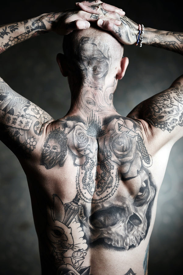 Studio portrait of a tattooed man with his back turned away from the camera. Shot by Norwich commercial, freelance portrait photographer Matt Keal.