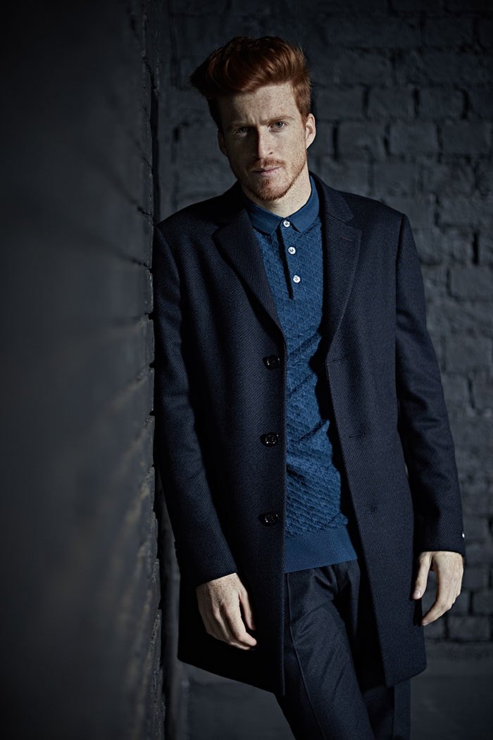 Fashion portrait of a red-haired man leaning against a brick wall for a commercial campaign client. Shot by Norwich commercial, freelance portrait photographer Matt Keal.