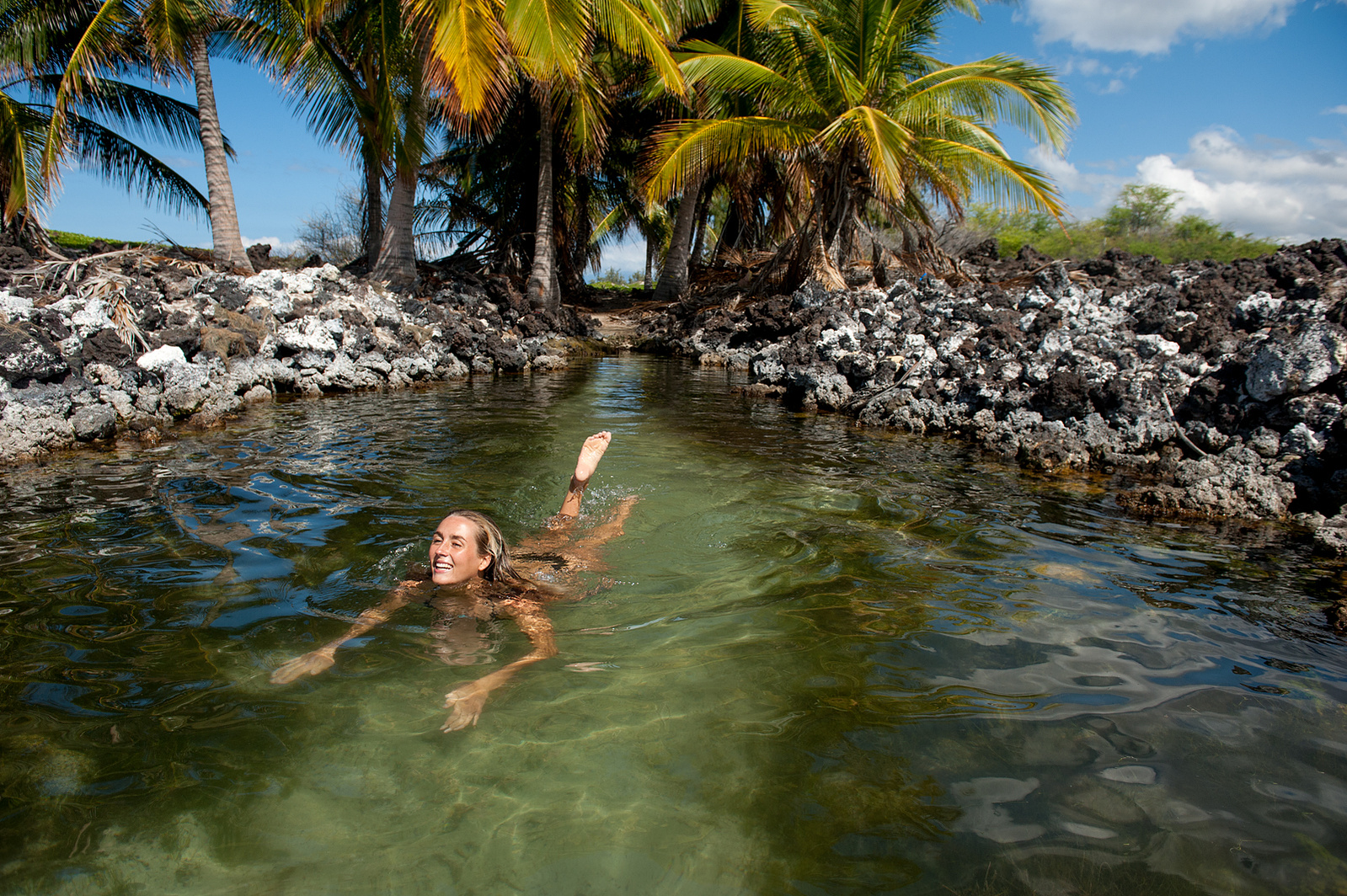 ANna Erhgott soaks up the sun in a mini tidal lagoon on the coast of the Big Island.
