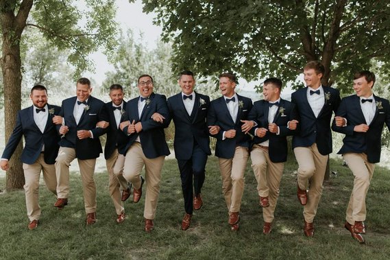 Groom and group of guys photographed at their wedding in Minnesota 