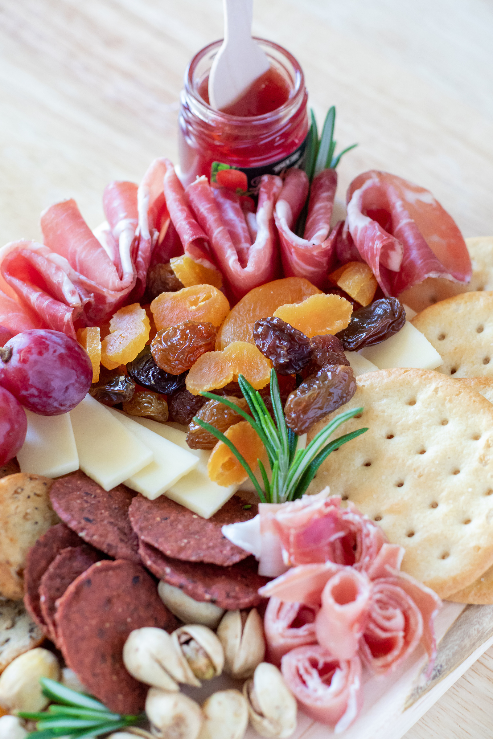 small graze board, charcuterie on wood board. assembled in Wilmington and ; or surrounding areas. Fruits jams, proteins and cheeses.