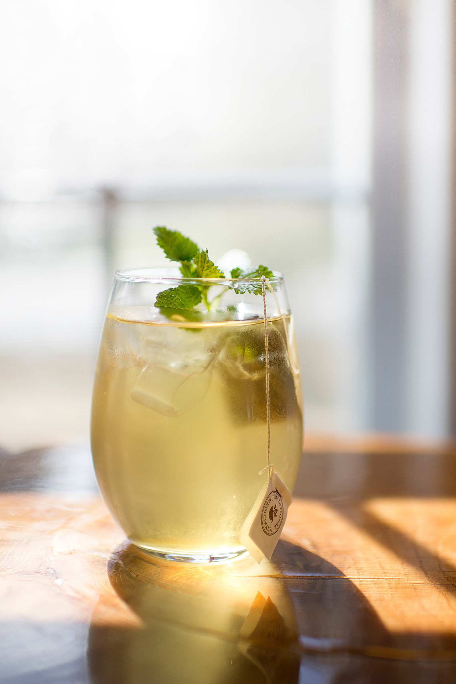bright, bold, green tea, cold, iced drink, wood, reflection